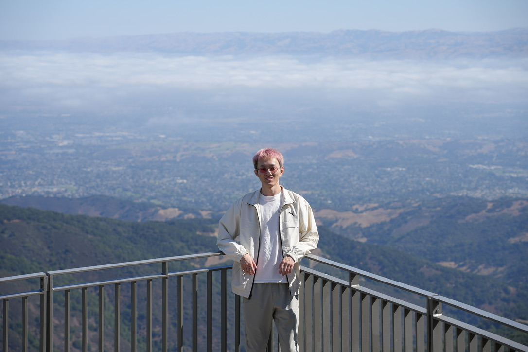 Xiaotong Wu outdoors at a scenic overlook